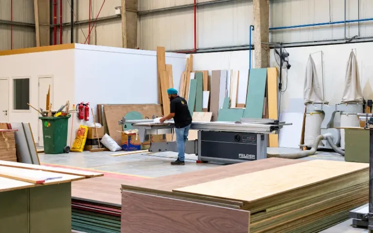 Who actually makes your fit-out? The question most Dubai clients never ask Our factory floor. The sheet stock in front goes through that panel saw behind it.
